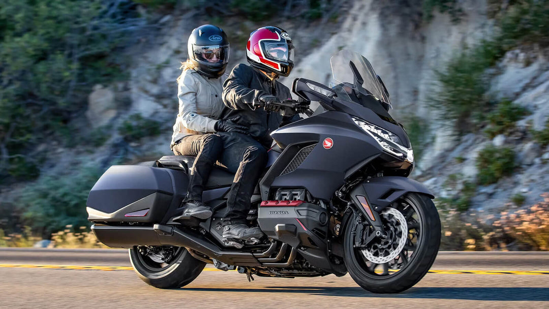 Two riders enjoying a scenic ride on a Honda Goldwing, showcasing its comfort and touring capabilities