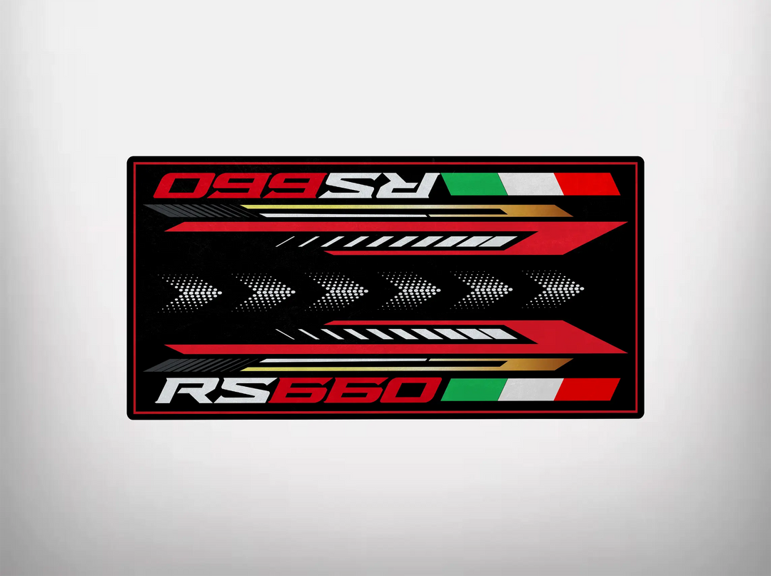 The Motorcycle Pit Mat for RS660 (Special Design) features RS660 in bold red and white lettering on a black background, complemented by red, green, and white stripes with triangular patterns, making it ideal for any garage.