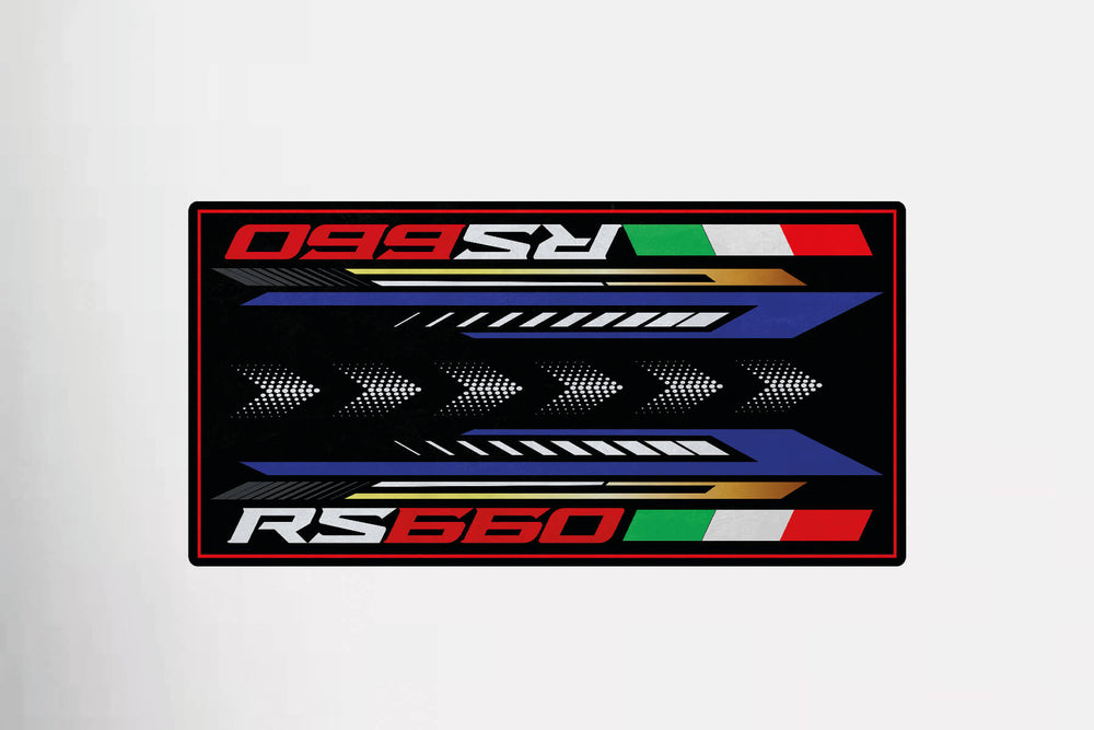 The Motorcycle Pit Mat for RS660 showcases RS660 in bold red and white on a black backdrop. Vivid arrows, blue, gold, and white stripes enhance the design, with Italian flag motifs on the top and bottom edges. Ideal as a motorcycle mat for garage decoration.