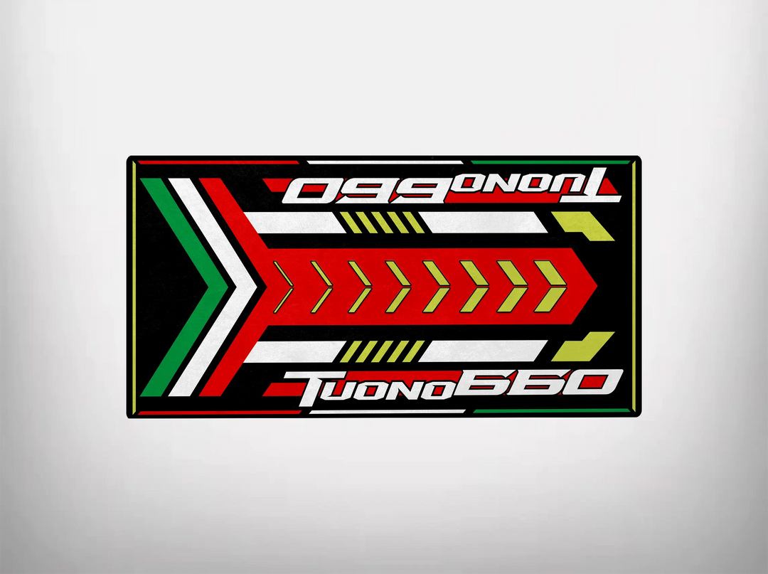 The Motorcycle Pit Mat for Tuono 660 (Special Design) features Tuono 660 text with vibrant red, green, and white arrows on a black background, adding a dynamic touch to your garage.