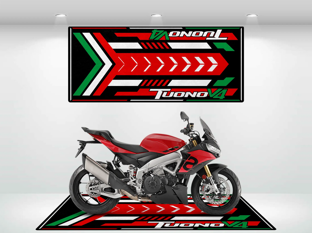 A red and black motorcycle rests on the Motorcycle Pit Mat for Tuono V4 Italian, vibrant with red, green, and white arrows and Tuono V4. Above, a matching wall panel complements this sleek design.