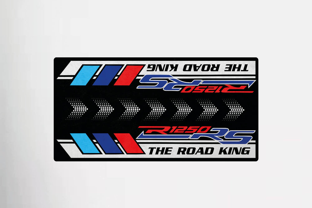 The Motorcycle Pit Mat for R1250 RS showcases a striking design with The Road King R1250 RS in red and blue on a black background, highlighted by angular stripes.