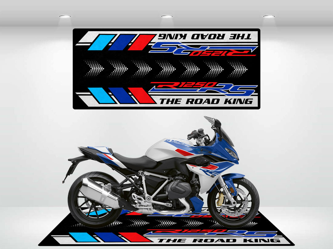 A blue, white, and red motorcycle is parked on a themed Motorcycle Pit Mat emblazoned with The Road King and R1250 RS, with a matching backdrop that enhances the colorful display.