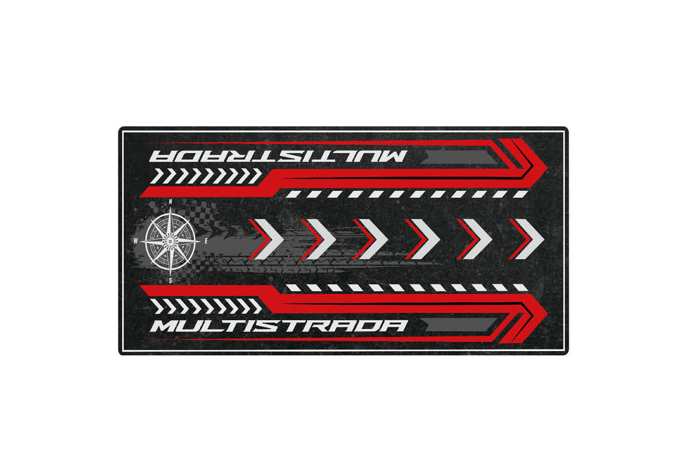 The Motorcycle Pit Mat, a Motorcycle Mat for Multistrada, features bold red MULTISTRADA text, red and white chevrons, and a stylized compass on a dark textured surface, ideal for any enthusiasts space.