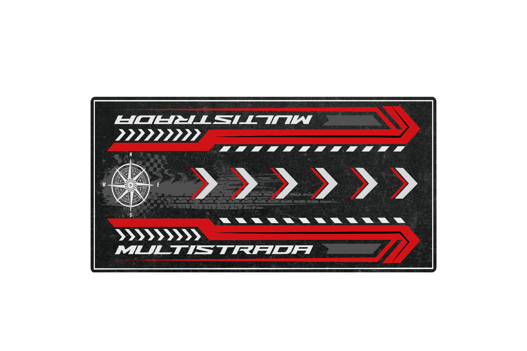 The Motorcycle Pit Mat, a Motorcycle Mat for Multistrada, features bold red MULTISTRADA text, red and white chevrons, and a stylized compass on a dark textured surface, ideal for any enthusiasts space.