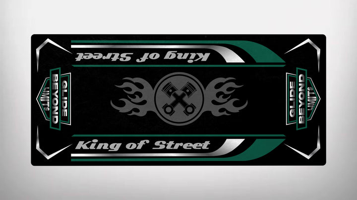 The Motorcycle Pit Mats King of Street design on a black background features crossed wrenches, symbolizing Harley Davidsons durability. Green and white accents frame it, with GLIDE BEYOND LIMITS racing along the sides like a roaring motorcycle mat.