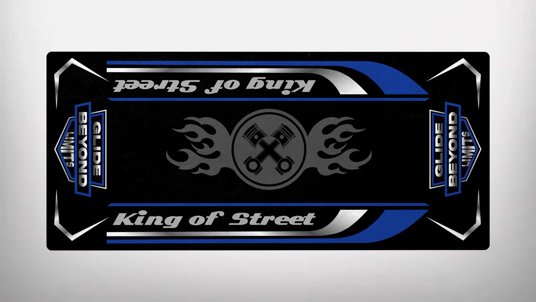 The Motorcycle Pit Mats Motorcycle Mat for King of Street - Glide Beyond Limits features a black rectangular design with King of Street in stylish script, accompanied by flaming pistons. Blue, white, and silver accents enhance this dynamic piece, perfect for any motorbike mat collection.