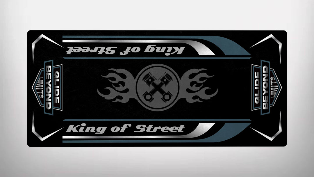 The Motorcycle Pit Mat’s rectangular black and silver design labeled King of Street embodies rugged durability. A central flaming wrench emblem with Harley Davidson-inspired silver and teal accents makes the mat a favorite among enthusiasts, with text repeated upside down for flair.