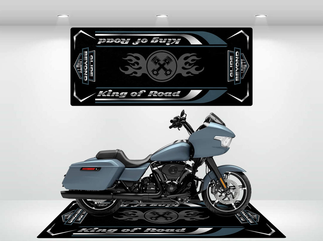 A sleek gray Harley Davidson rests on a Motorcycle Pit Mat adorned with Road Glide banners. The minimalist, well-lit setting is enhanced by a flame and wrench motif that complements the motorcycles design.