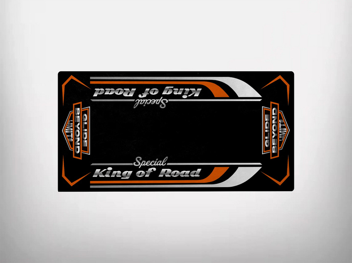 The Motorcycle Pit Mat boasts a rectangular black design with orange and white geometric accents. King of Road Special is prominently styled, while Super Senior appears smaller. The Harley Davidson-inspired symmetrical design adds a bold touch to any garage space.