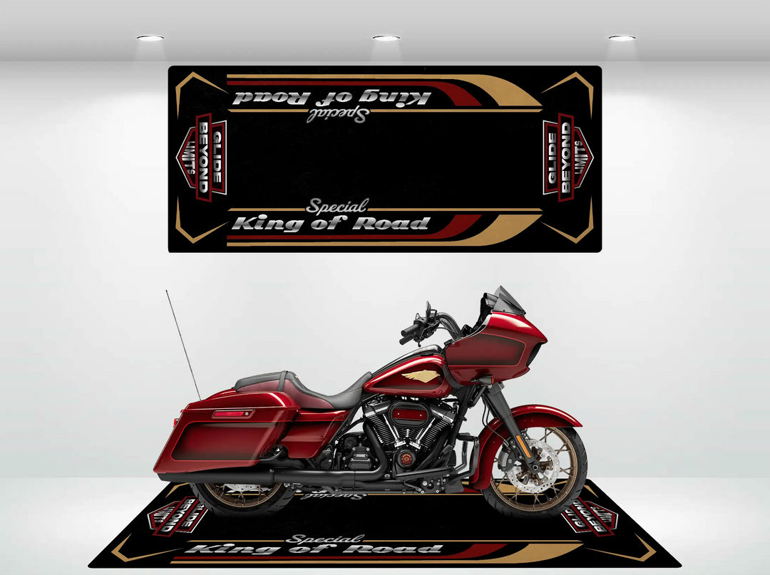 A shiny red motorcycle, likely a Harley Davidson, is showcased on a Motorcycle Pit Mats Motorcycle Mat for Road Glide Special with gold and maroon designs. Matching wall panels echo the theme.