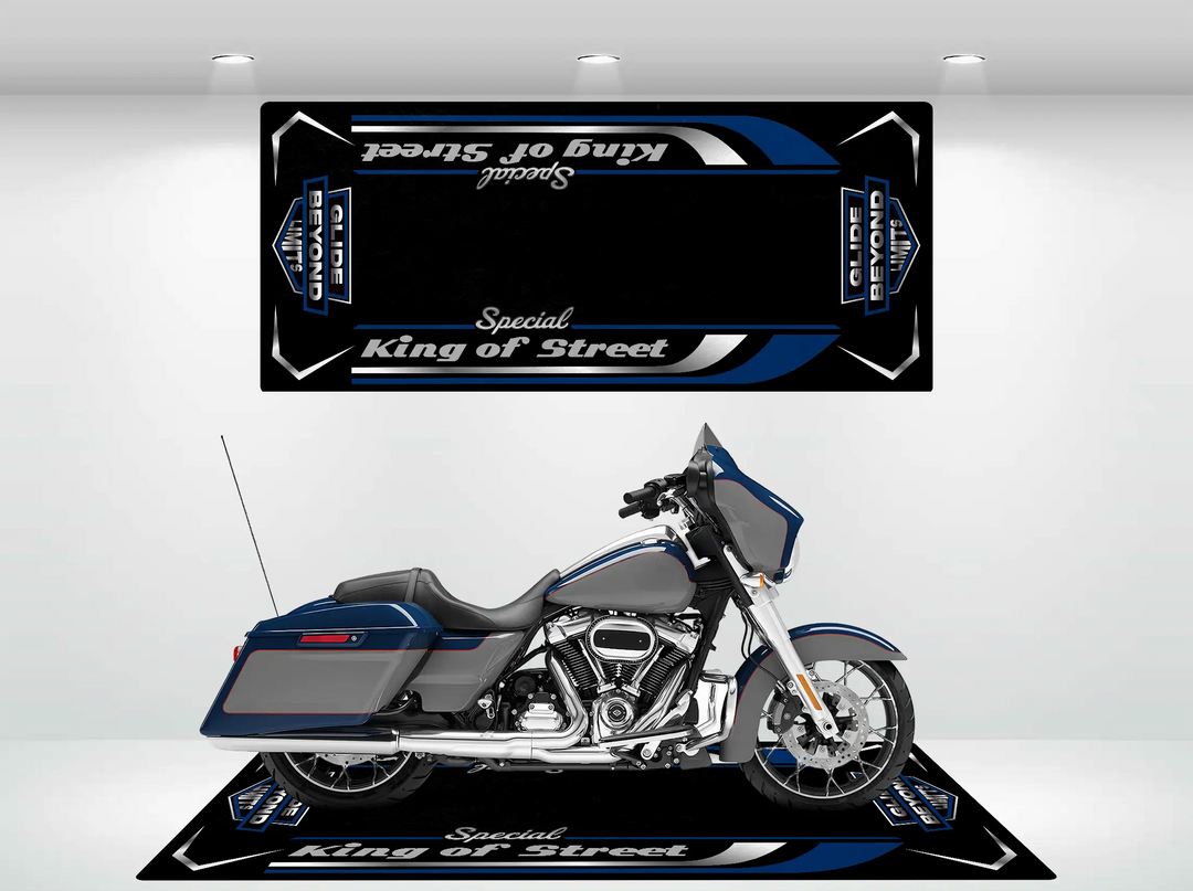 A sleek blue and silver Harley Davidson sits on a Motorcycle Pit Mat branded as Motorcycle Mat for Street Glide Special, with a matching black banner above it. The setup looks like a showroom display.