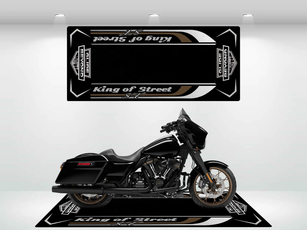 A sleek Harley Davidson motorcycle is parked on a matching black Motorcycle Pit Mat, showcasing Street Glide and ST on the mat and backdrop. The well-lit room highlights the bikes design and durability, ensuring it stands out as a true masterpiece.