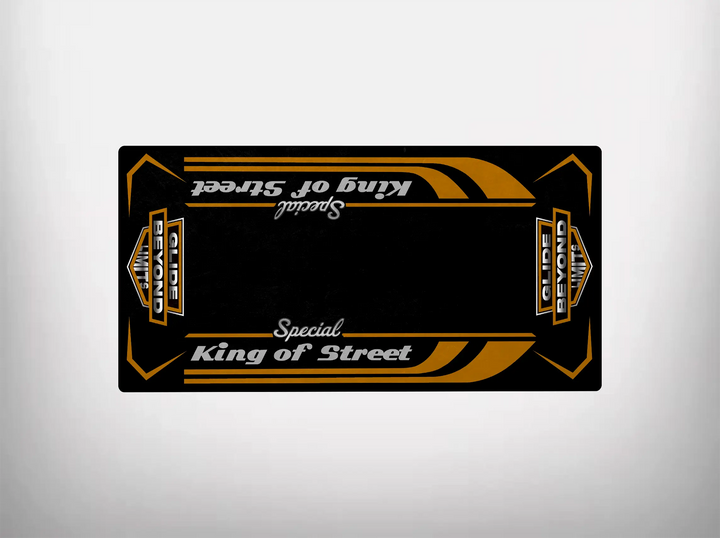 The Motorcycle Pit Mat, named the Motorcycle Mat for King of Street Special, features a striking black and gold design with Special King of Street and Globe Demon text. It resembles a Harley Davidson motif with symmetrical stripes and patterns along its length.