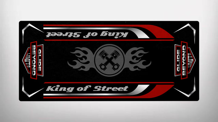 The Motorcycle Pit Mat features a rectangular black design with red and white accents, a central gray circle with crossed pistons and flames, echoing Harley Davidsons spirit. King of Street in stylized fonts and red-bordered verticals proclaim Glide Beyond Limits, as durable as its name suggests.