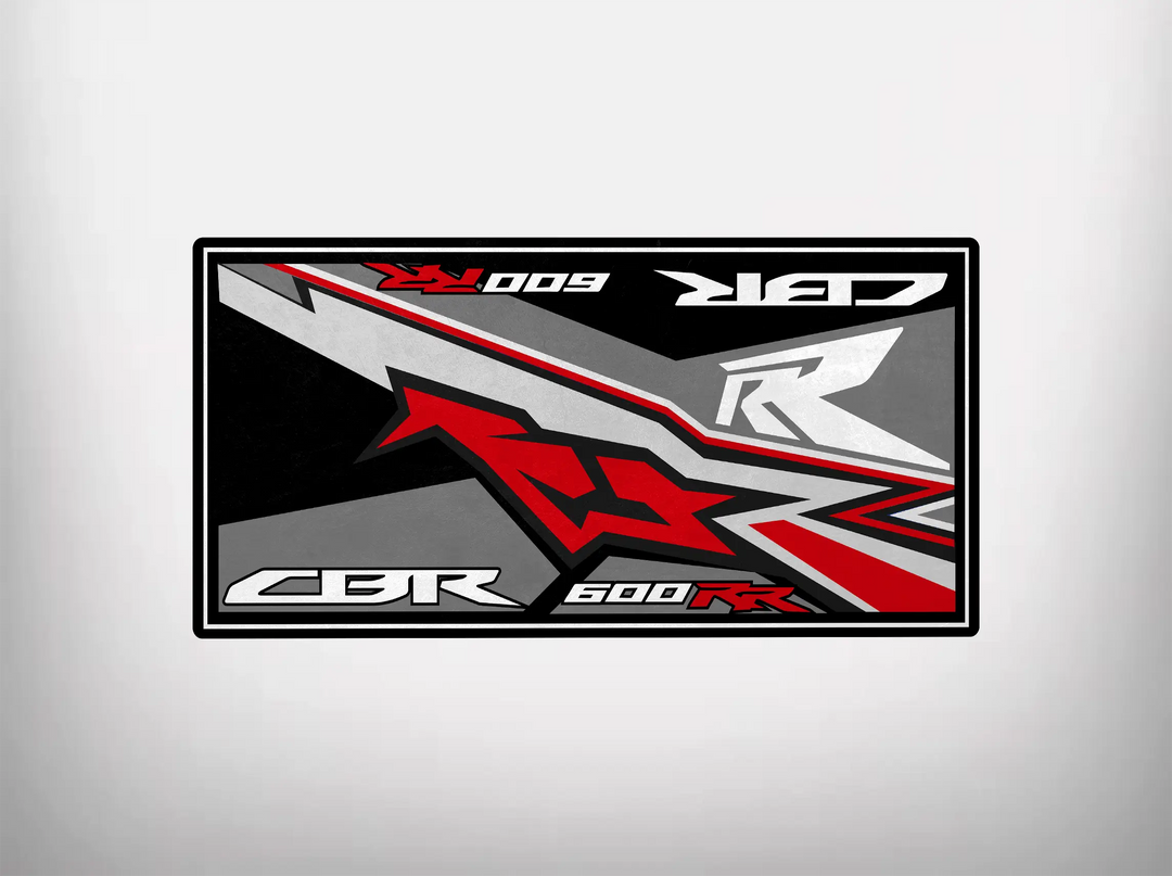 Featuring CBR 600 RR in bold, this design is inspired by the Motorcycle Pit Mat for Honda CBR600RR. It incorporates angular shapes in red, black, gray, and white for a dynamic and modern look reminiscent of a motorcycle garage mat.