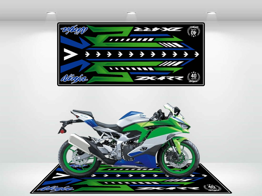 A green, blue, and white sport motorcycle is parked on a stylish Motorcycle Pit Mat for the Ninja ZX-4RR 40th Anniversary. It stands against matching graphic panels with geometric designs in green, blue, and black featuring colorful stripes and arrows.