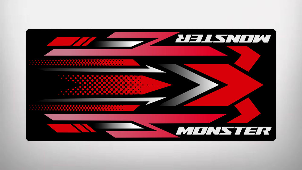 The Motorcycle Pit Mats Motorcycle Mat for Monster showcases a striking design with red, black, and white geometric shapes, bold right-facing arrows, and the word MONSTER in white at both ends.