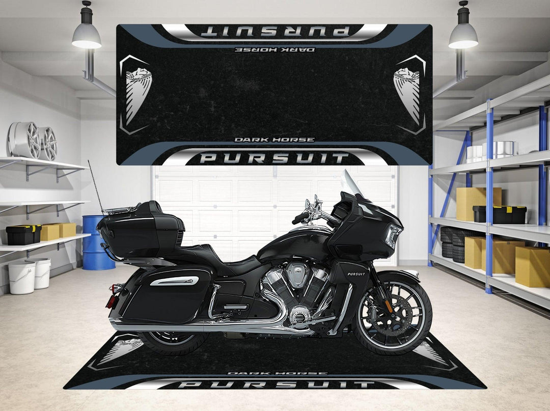 Inside a modern garage, a sleek black motorcycle sits on a Motorcycle Pit Mats Garage Mat for Indian Pursuit Dark Horse. Shelves with tools and items line the walls, which display bold Pursuit and Dark Horse designs.