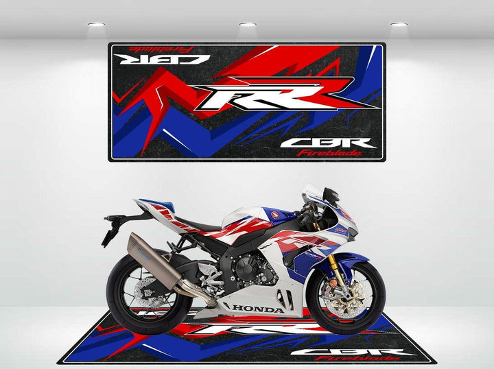 A Honda CBR motorcycle is displayed on a Motorcycle Pit Mat in a showroom, featuring the Motorcycle Mat for Honda CBR1000RR Fireblade with bold red, blue, and black designs and the CBR and Fireblade text.