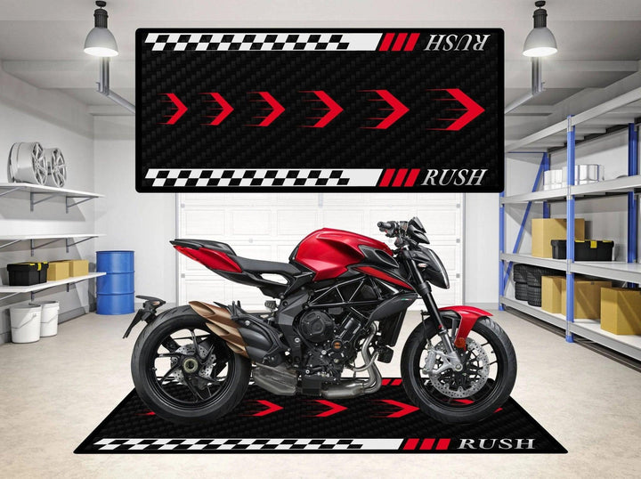 A red motorcycle rests on the Motorcycle Pit Mat designed for MV Agusta Rush, featuring bold white RUSH lettering and red arrows. This racing-themed mat enhances the modern, industrial atmosphere of the room, which also includes shelves showcasing assorted items.