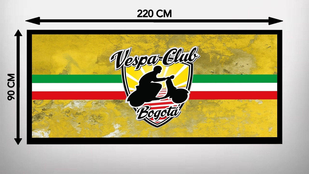 A yellow textured background showcases the Motorcycle Pit Mats Vespa Club design, resembling a garage mat. It features a person on a Vespa atop a shield with red, white, and green stripes. The dimensions are 220 cm wide by 90 cm high.