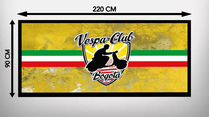 A yellow textured background showcases the Motorcycle Pit Mats Vespa Club design, resembling a garage mat. It features a person on a Vespa atop a shield with red, white, and green stripes. The dimensions are 220 cm wide by 90 cm high.