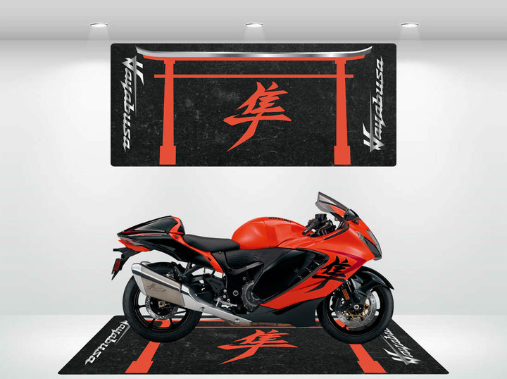 A Suzuki Hayabusa sports motorcycle sits on a Motorcycle Pit Mat, featuring red and black hues with Japanese kanji symbols. The backdrop mirrors this design, creating a cohesive aesthetic in the showroom.