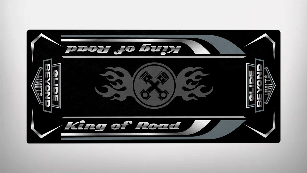 This Motorcycle Pit Mat, Motorcycle Mat for King of Road - Glide Beyond Limits, is rectangular and black, featuring King of Road with flames and crossed wrenches at its center. Glide Beyond appears on vertical side bars, with white and gray lines accentuating the edges for a sleek finish.