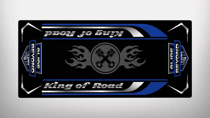 A black skateboard deck, styled like a Motorcycle Pit Mat, showcases blue and white accents. It reads King of Road and Glide Beyond Limits, featuring two crossed wrenches with flames in the center.