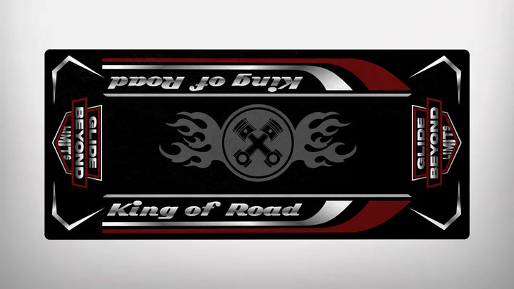 A black Motorcycle Pit Mat features red and white borders with central flaming pistons. It displays mirrored text: King of Road and Glide Beyond Limits, resembling a sleek motorcycle garage mat design.