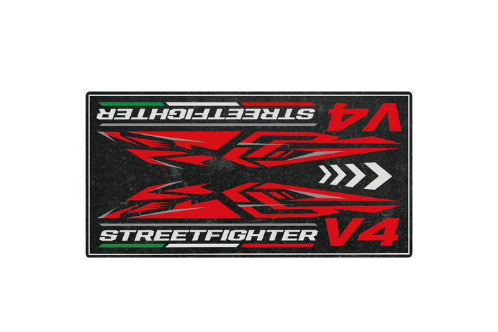 A Motorcycle Pit Mat for Street Fighter V4 showcases an abstract red and black design with mirrored angular patterns on a dark backdrop, evoking the essence of the motorcycle.