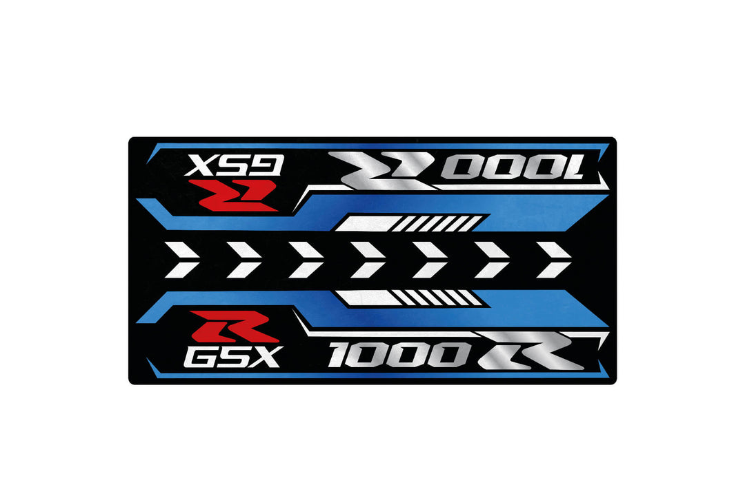 The Motorcycle Pit Mat for Suzuki GSX-R1000R 2025 features a rectangular design with metallic blue, silver, red, and black elements. It includes right-pointing arrows, XSR and GSX, plus the numbers 1000 and 0001, creating a dynamic automotive-inspired style.