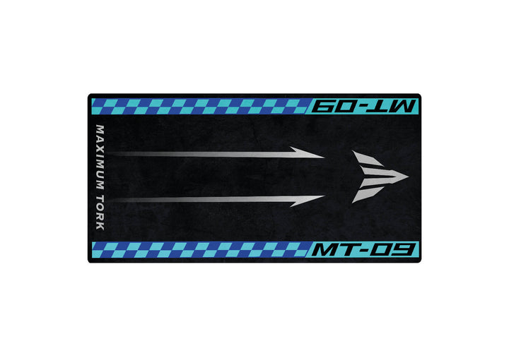 The Motorcycle Pit Mat for Yamaha MT-09 is rectangular with a black background, blue and black checkered borders, white upward arrows in the center, MAXIMUM TORK on the left, and MT-09 on the right.