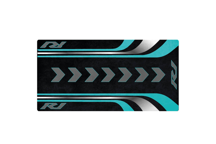 A black rectangular card with teal and white diagonal stripes and chevron patterns, reminiscent of a Motorcycle Mat for Yamaha R1 by Motorcycle Pit Mat, features the initials RJ on the top left and bottom right corners.