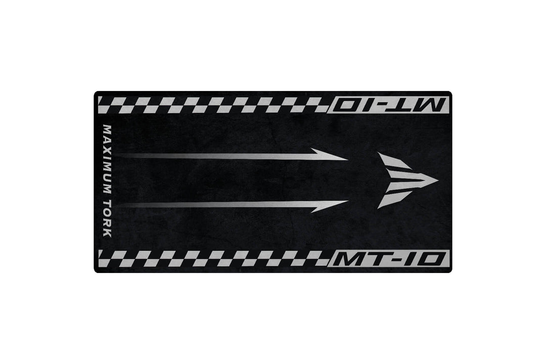 The Motorcycle Pit Mat for Yamaha MT-10 is a black and gray mat featuring a road theme with two white arrows, MAXIMUM TORQUE on the left, MT-10 on top and bottom edges, and checkered side borders.