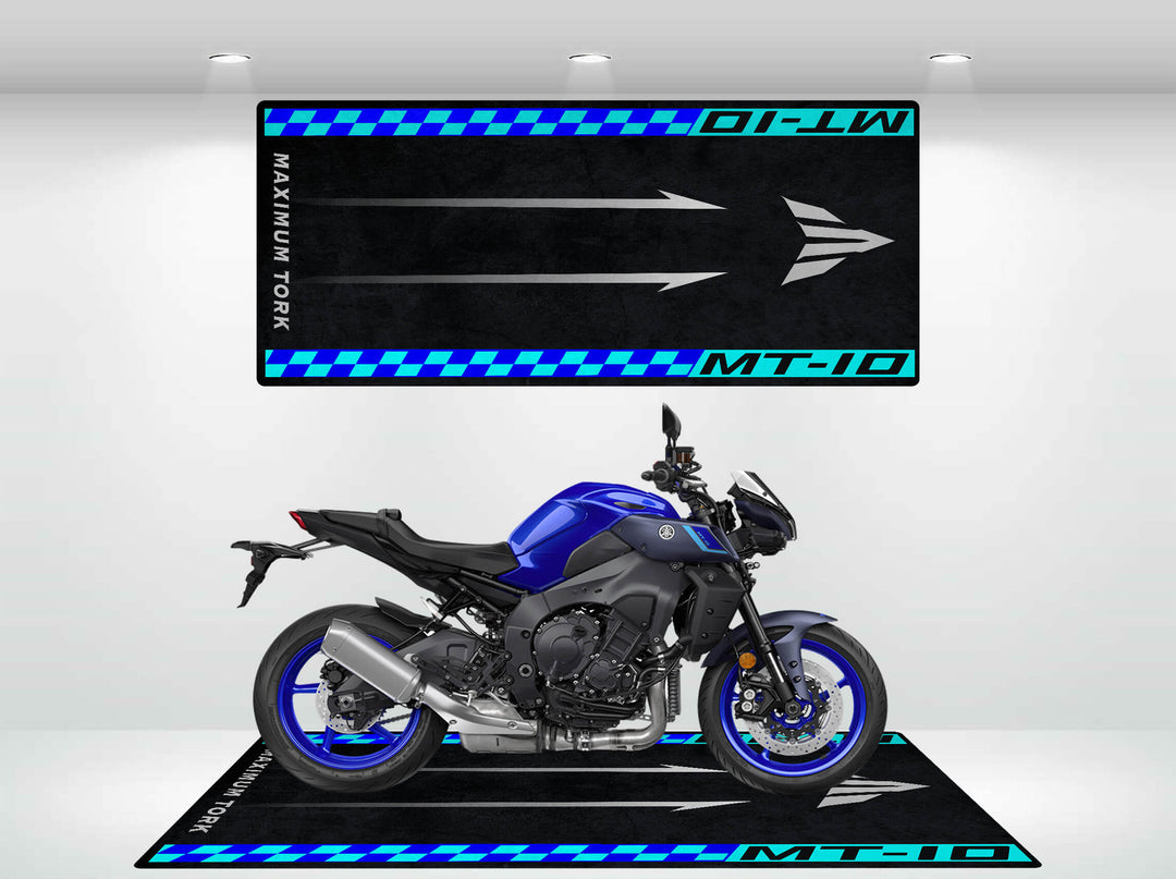 A blue and black motorcycle sits on a Motorcycle Pit Mat featuring blue checkered accents, with MT-10 and Maximum Torque in white and blue, highlighting the Yamaha MT-10s power and style.