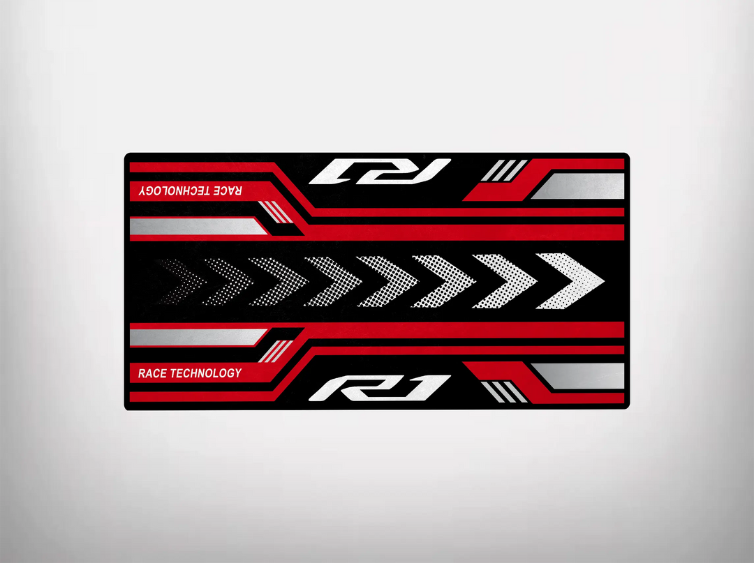 The Motorcycle Pit Mat for Yamaha R1 2025 Design features a rectangular graphic with red, black, and silver elements, right-pointing arrows, and RACE TECHNOLOGY and R1 phrases on a grey background—perfect for any motorcycle garage.