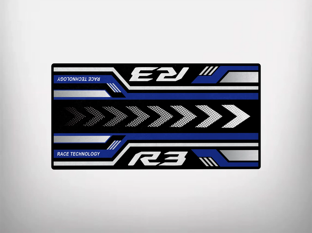 The Motorcycle Pit Mat for Yamaha R3 2025 features a rectangular design with bold black, white, and blue geometric patterns. Arrows point right alongside Race Technology and R3 text. Its clean white background makes it an ideal mat to showcase your bike.