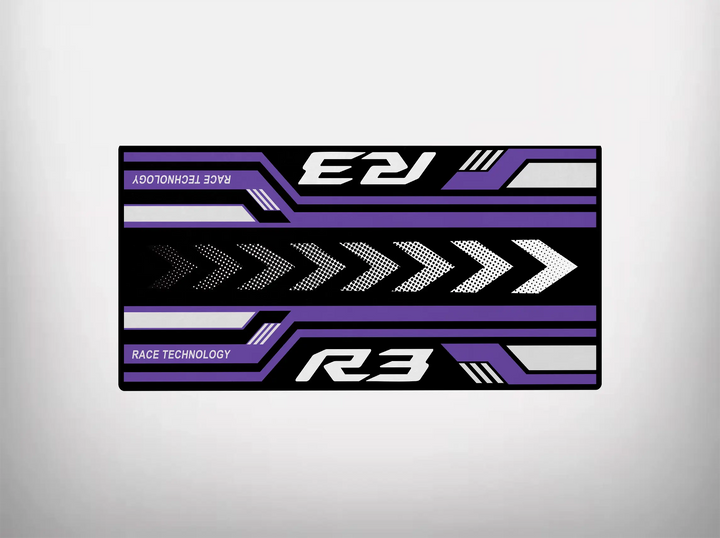 The Motorcycle Pit Mat for Yamaha R3 2025 boasts a rectangular design with R3 and RACE TECHNOLOGY in white and purple on a black backdrop. With bold white arrows and geometric accents in purple and gray, it offers a dynamic, racing-inspired look ideal for any motorcycle garage mat.