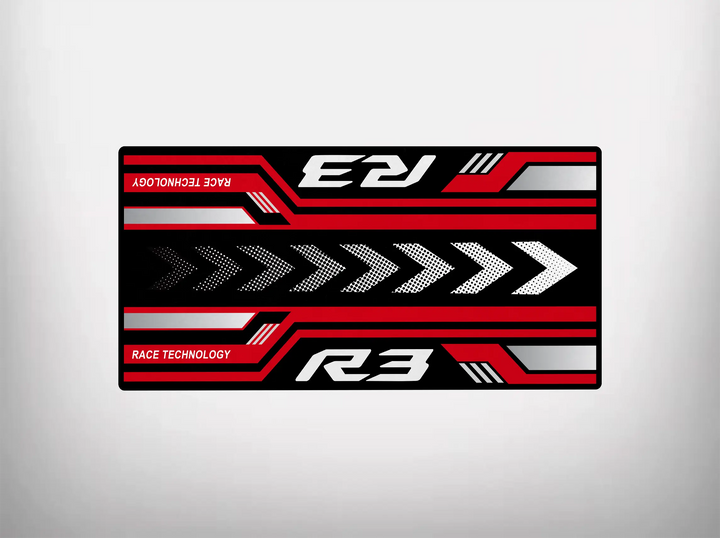 The Motorcycle Pit Mat for Yamaha R3 2025 features a rectangular design with R3 in stylized text at the corners and Race Technology on the sides. The center showcases red, white, and black arrows on a contrasting background—perfect for your motorbike mat needs.