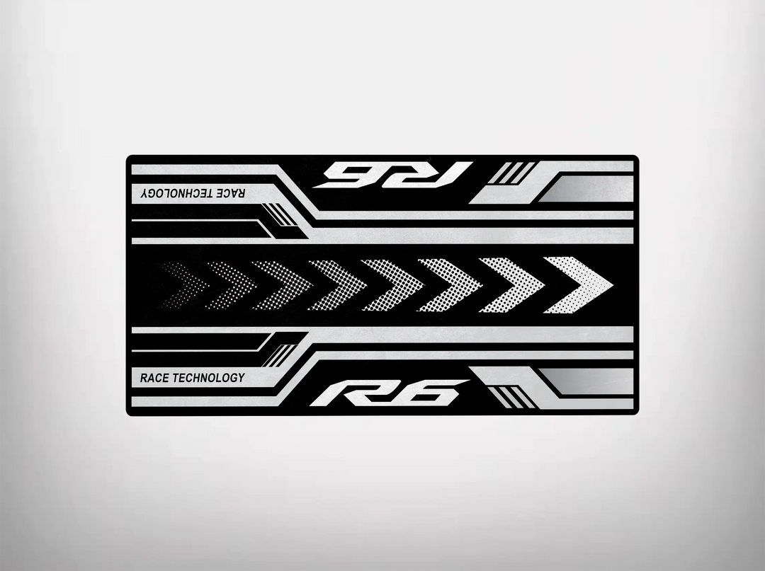 The Motorcycle Pit Mat for Yamaha R6 features a black rectangular design with bold white arrows pointing right and horizontal lines, enhanced by R6 and Race Technology text. The light gray background offers a clean, modern look, perfect for your garage floor.