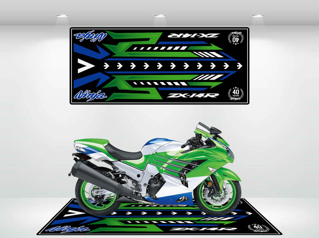 A green and white sport motorcycle sits on a Motorcycle Pit Mat for Ninja ZX-14R 40th Anniversary in a well-lit showroom. Matching black, green, and blue art panels with arrows and Ninja ZX-14R are displayed above and below the bike.